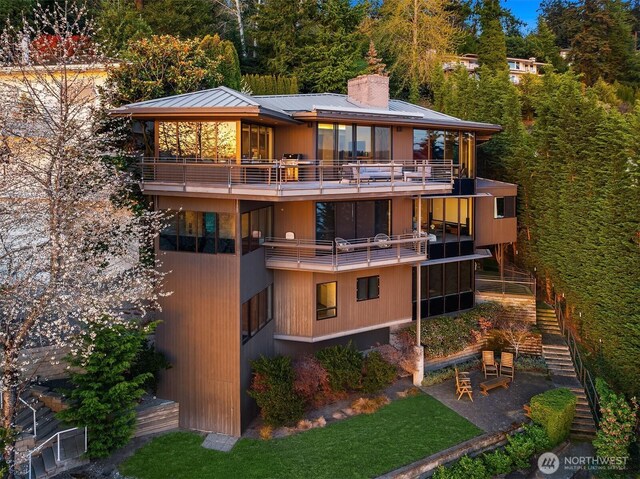 7703 W Mercer Way, Mercer Island, WA 98040 - rear view of property with a balcony, stairway, a chimney, a patio area, and metal roof