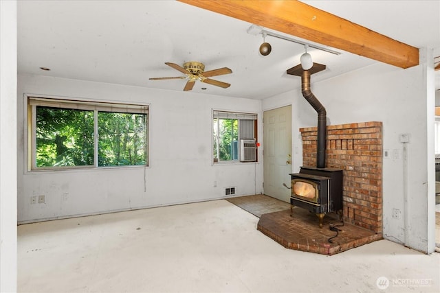 44119 Fir Rd, Gold Bar, WA 98251 - unfurnished living room featuring unfinished concrete floors, a wood stove, a ceiling fan, and cooling unit