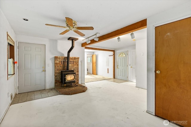 44119 Fir Rd, Gold Bar, WA 98251 - unfurnished living room with ceiling fan, a wood stove, and concrete floors