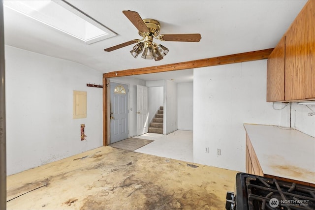 44119 Fir Rd, Gold Bar, WA 98251 - kitchen featuring a skylight, unfinished concrete floors, a ceiling fan, gas range, and electric panel