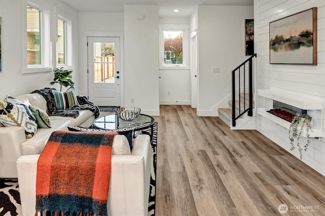 7350 21st Ave NW, Seattle, WA 98117 - living area with wood finished floors, stairs, a fireplace, and recessed lighting