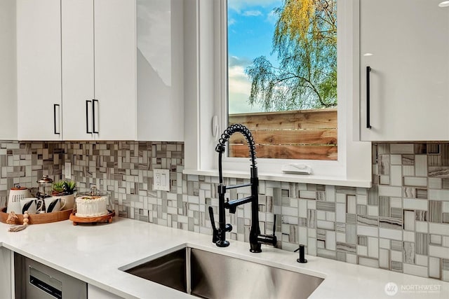 7350 21st Ave NW, Seattle, WA 98117 - kitchen featuring decorative backsplash, white cabinetry, light countertops, stainless steel dishwasher, and modern cabinets