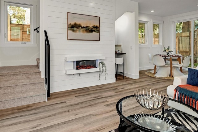 7350 21st Ave NW, Seattle, WA 98117 - living area featuring wood finished floors, stairs, a glass covered fireplace, and recessed lighting
