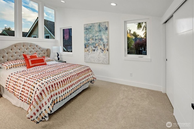 7350 21st Ave NW, Seattle, WA 98117 - carpeted bedroom with vaulted ceiling, recessed lighting, and a closet