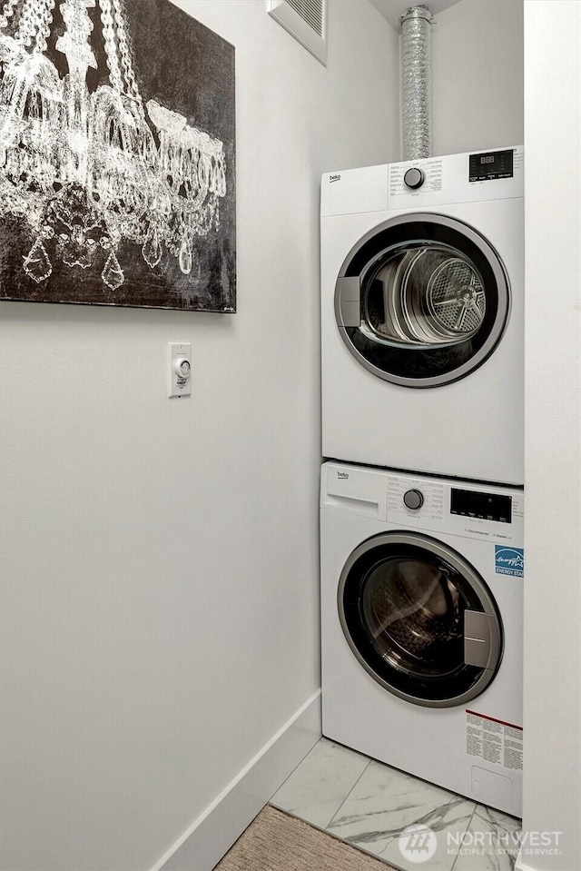 7350 21st Ave NW, Seattle, WA 98117 - laundry area featuring estacked washer and dryer and marble look tiles
