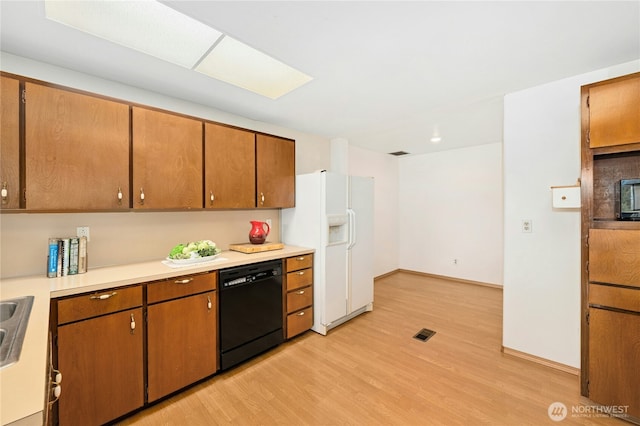 10410 260th St E, Graham, WA 98338 - kitchen with dishwasher, white refrigerator with ice dispenser, light wood-style floors, light countertops, and brown cabinetry