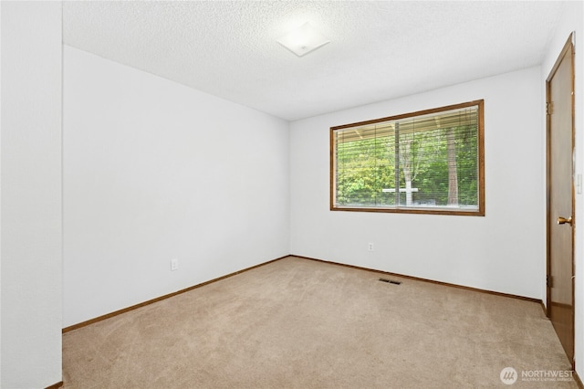 10410 260th St E, Graham, WA 98338 - unfurnished bedroom featuring carpet floors, baseboards, and a textured ceiling