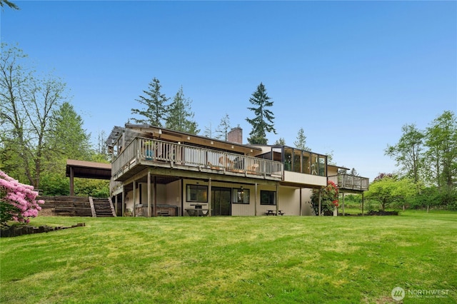 10410 260th St E, Graham, WA 98338 - rear view of house featuring a deck, a lawn, and a chimney