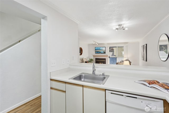 260 Newport Way NW Unit C24, Issaquah, WA 98027 - kitchen with a sink, dishwasher, ornamental molding, light wood-style flooring, and light countertops