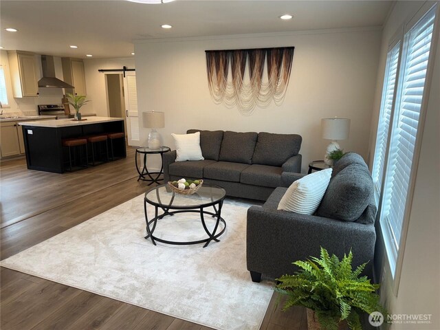 702 Bryce Pl SW, Mattawa, WA 99349 - living area featuring a barn door, recessed lighting, wood finished floors, and ornamental molding