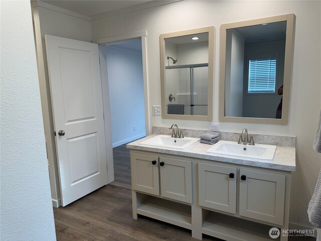 702 Bryce Pl SW, Mattawa, WA 99349 - full bath featuring a shower stall, wood finished floors, double vanity, and ornamental molding