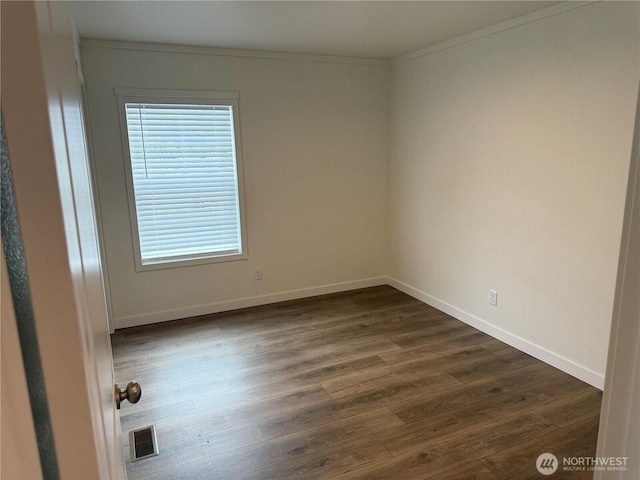 702 Bryce Pl SW, Mattawa, WA 99349 - unfurnished room with dark wood-style flooring, ornamental molding, and baseboards