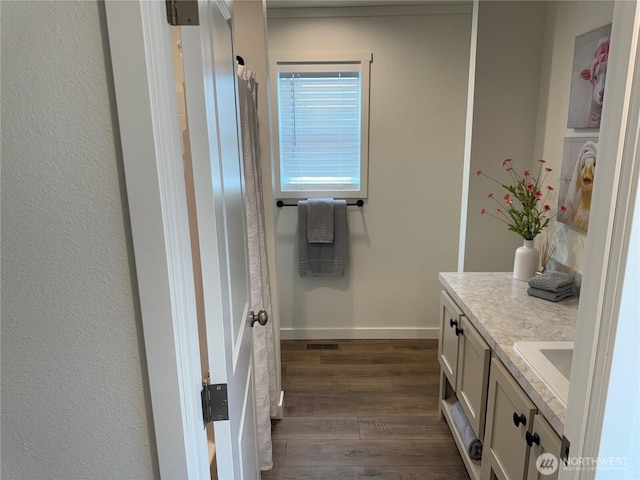 702 Bryce Pl SW, Mattawa, WA 99349 - bathroom with vanity, wood finished floors, and baseboards