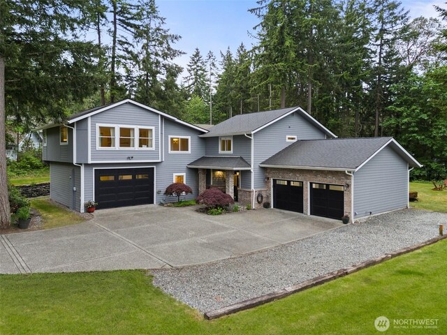 464 7th Ave, Fox Island, WA 98333 - view of front of house featuring driveway, an attached garage, and a front yard