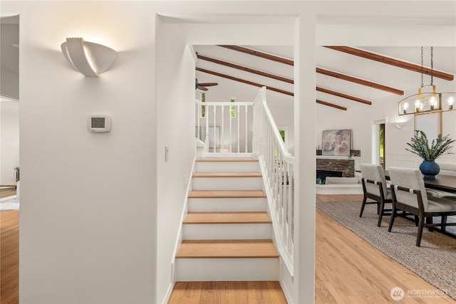 464 7th Ave, Fox Island, WA 98333 - staircase featuring a chandelier, wood finished floors, and a fireplace