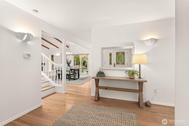 464 7th Ave, Fox Island, WA 98333 - hall with wood finished floors, stairway, baseboards, and lofted ceiling