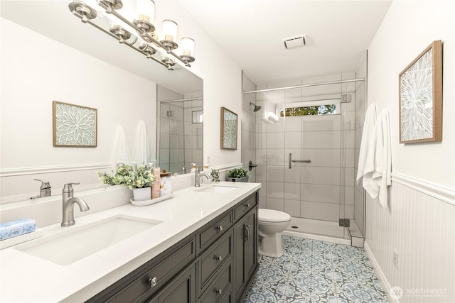 464 7th Ave, Fox Island, WA 98333 - bathroom with tile patterned floors, a shower stall, toilet, and double vanity