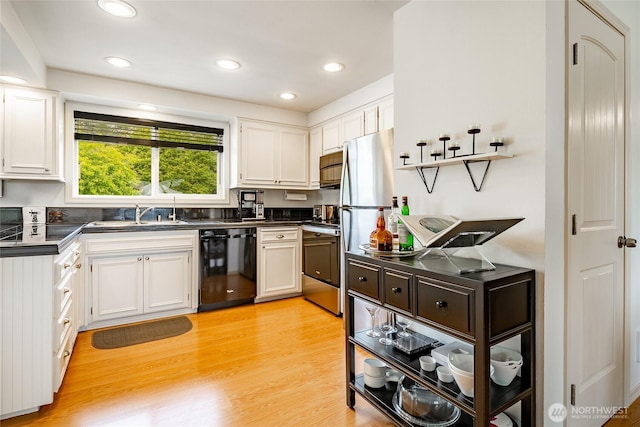 8039 Niska Rd, Blaine, WA 98230 - kitchen with dishwasher, dark countertops, a sink, white cabinets, and recessed lighting