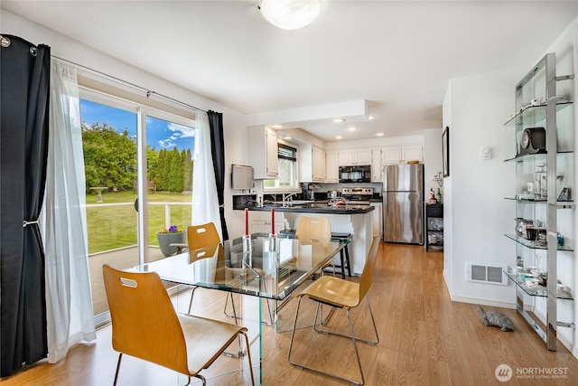 8039 Niska Rd, Blaine, WA 98230 - dining space with light wood-style floors, recessed lighting, and baseboards