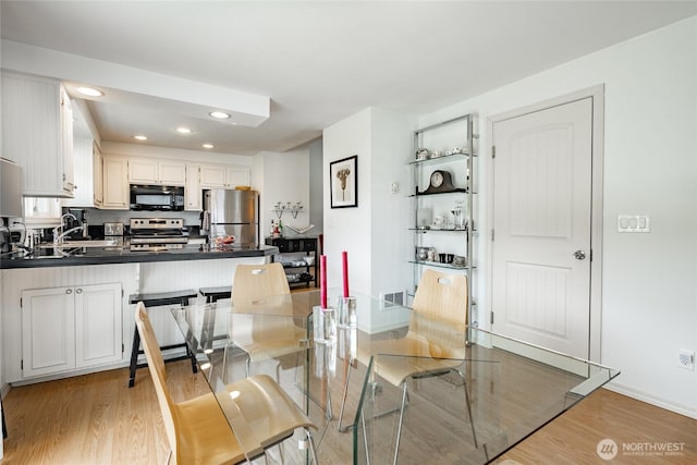 8039 Niska Rd, Blaine, WA 98230 - dining area featuring light wood-style flooring, recessed lighting, and baseboards