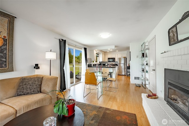 8039 Niska Rd, Blaine, WA 98230 - living area with a fireplace and light wood-style floors