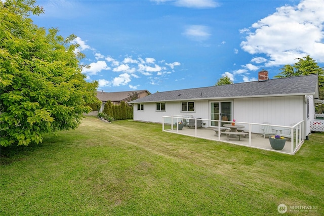 8039 Niska Rd, Blaine, WA 98230 - back of property with a patio, a chimney, a yard, and roof with shingles