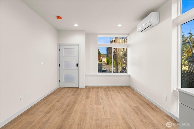 5517A 9th Ave NW, Seattle, WA 98107 - empty room with a wall mounted AC, light wood-type flooring, baseboards, and recessed lighting