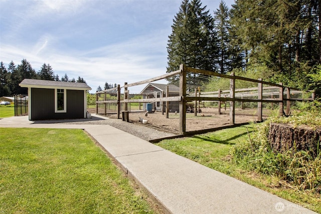 view of grassy yard featuring an outbuilding and a playground