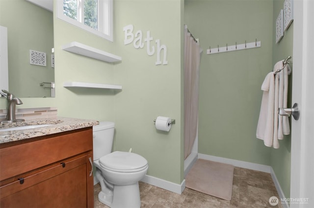 full bathroom with toilet, baseboards, vanity, and a shower with shower curtain