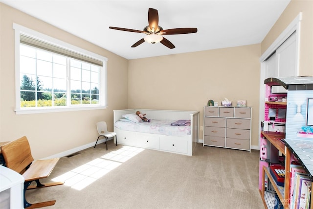 carpeted bedroom with baseboards and a ceiling fan