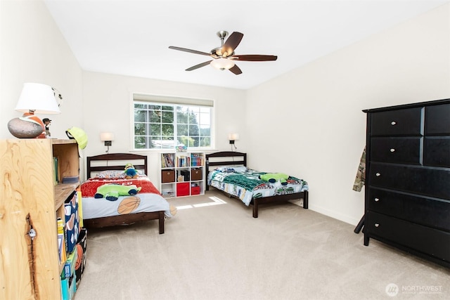 carpeted bedroom with a ceiling fan and baseboards