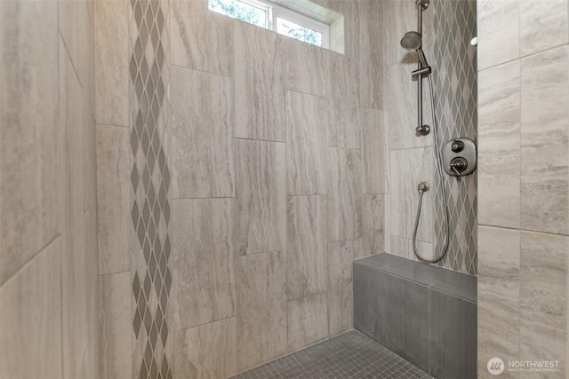 bathroom with tiled shower