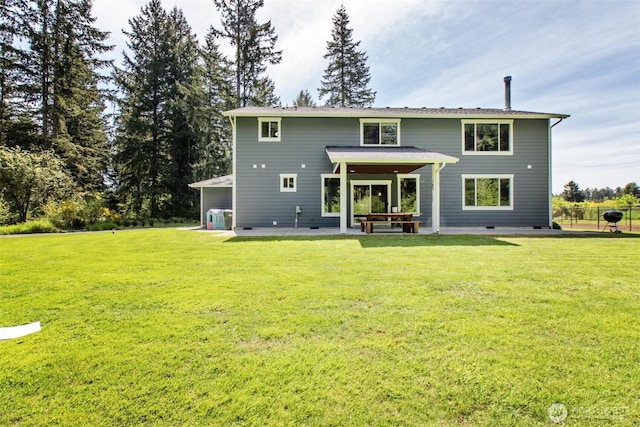 back of property with a patio area and a lawn