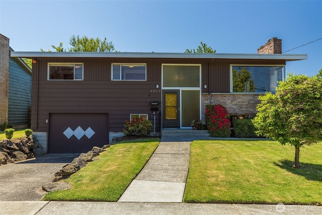 4839 S Mead St, Seattle, WA 98118 - raised ranch with a garage, a front lawn, asphalt driveway, and a chimney