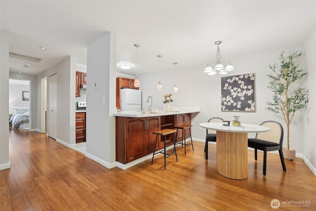 13209 Newcastle Way Unit A308, Newcastle, WA 98059 - dining space featuring light wood finished floors, a chandelier, and baseboards