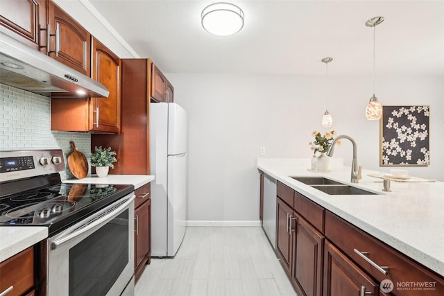 13209 Newcastle Way Unit A308, Newcastle, WA 98059 - kitchen featuring appliances with stainless steel finishes, a sink, under cabinet range hood, tasteful backsplash, and hanging light fixtures