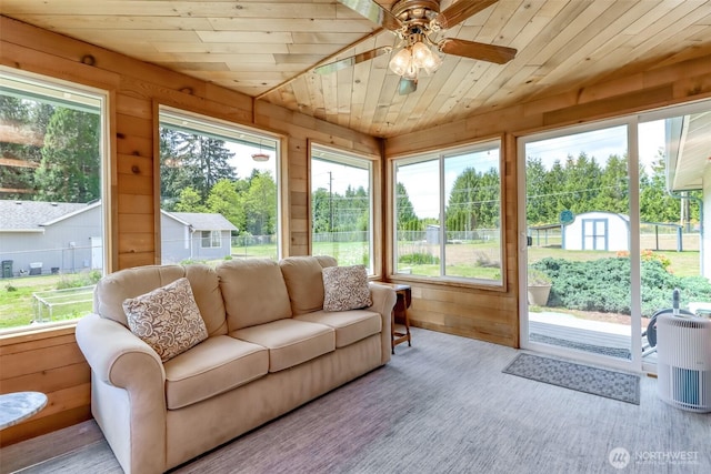 sunroom / solarium featuring a ceiling fan, wooden walls, an outdoor hangout area, and wooden ceiling