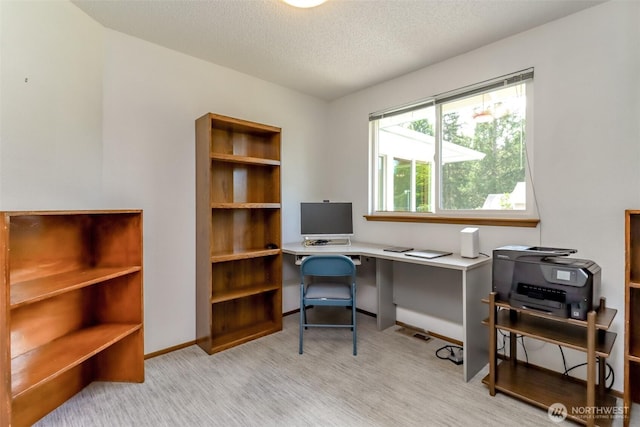 office area with a textured ceiling and baseboards