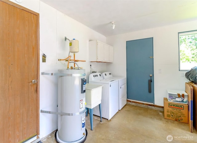 laundry room with water heater, cabinet space, and washer and dryer