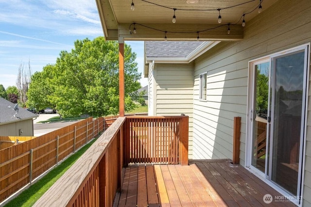 wooden terrace featuring fence