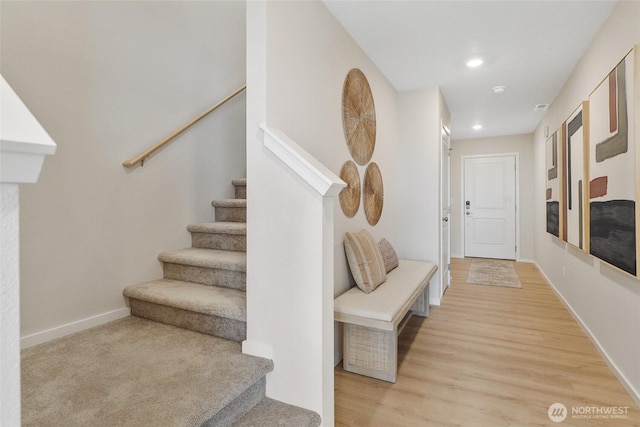 hall featuring stairway, light wood finished floors, recessed lighting, and baseboards