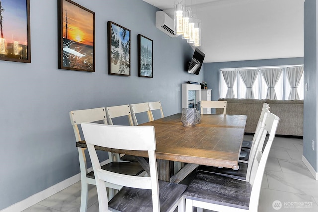 17421 73rd Ave NE, Arlington, WA 98223 - dining area with marble finish flooring, a chandelier, a wall mounted air conditioner, and baseboards