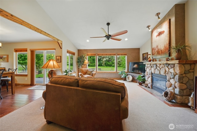 52 Buttonquail Ln, Walla Walla, WA 99362 - living area with vaulted ceiling, healthy amount of natural light, a fireplace, ceiling fan, and carpet