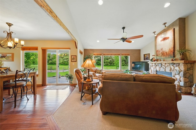 52 Buttonquail Ln, Walla Walla, WA 99362 - living area featuring lofted ceiling, ceiling fan, wood finished floors, a chandelier, and a stone fireplace