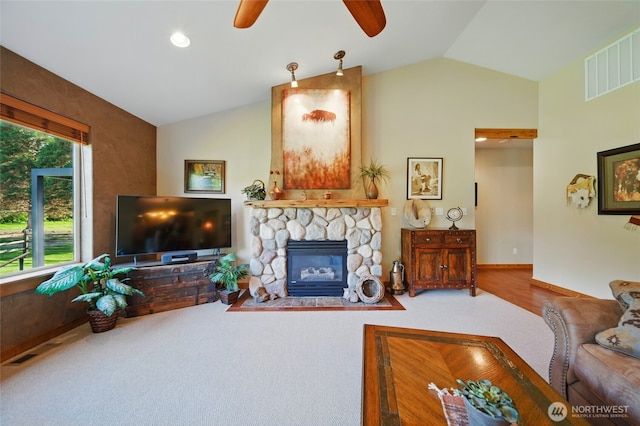 52 Buttonquail Ln, Walla Walla, WA 99362 - carpeted living room featuring ceiling fan, lofted ceiling, a stone fireplace, and baseboards