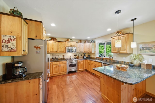52 Buttonquail Ln, Walla Walla, WA 99362 - kitchen featuring appliances with stainless steel finishes, a sink, a peninsula, light wood-type flooring, and recessed lighting