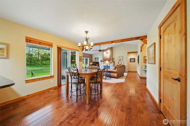 52 Buttonquail Ln, Walla Walla, WA 99362 - dining space featuring a chandelier, hardwood / wood-style floors, vaulted ceiling, and baseboards