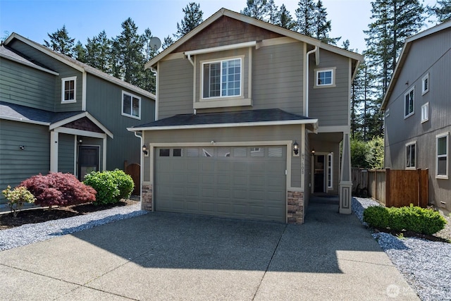 7608 181st Street Ct E, Puyallup, WA 98375 - view of front of property with an attached garage, concrete driveway, and stone siding