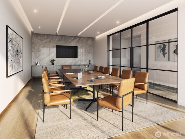 10232 NE 10th St Unit 506, Bellevue, WA 98004 - dining space featuring wood finished floors, recessed lighting, an accent wall, and baseboards