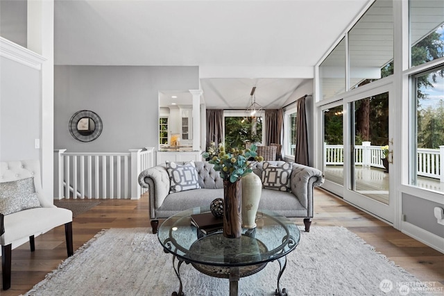 living room with plenty of natural light and wood finished floors